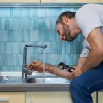 Man working on holiday plumbing problems