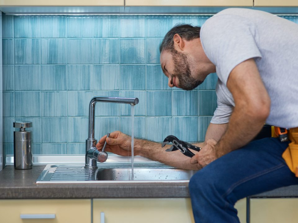 Man working on holiday plumbing problems